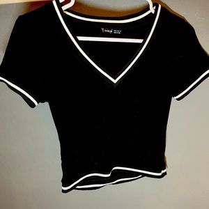 Black crop top from Shein with white detailing around sleeves and bottom!